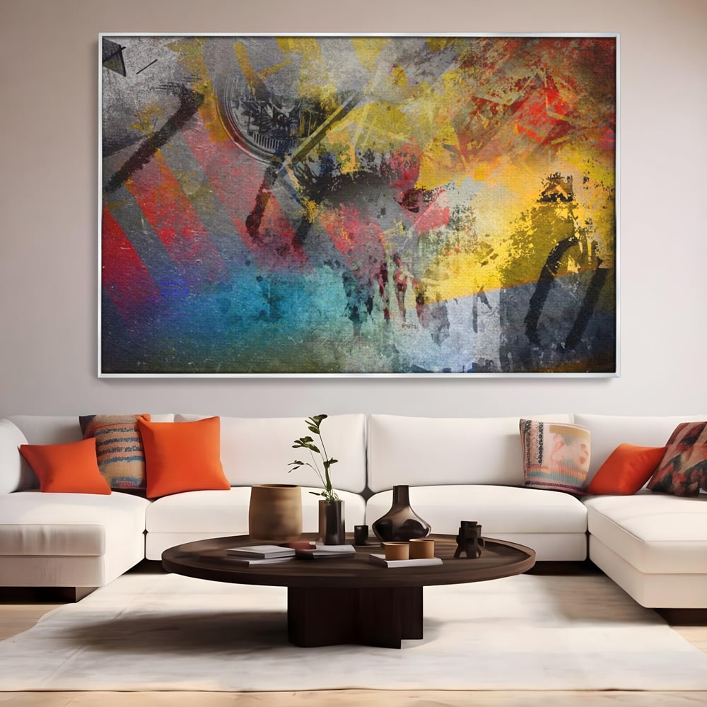 Tablou canvas cu pictura abstracta cu pete vibrante, in rama de aluminiu argintiu, pe perete intr-un living
